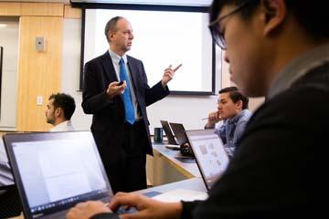 鶹Ӱ Professor Peter Nigro instructs students inside a tiered classroom in the Unistructure.